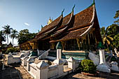 Wat Xieng Thong temple in Luang Prabang, Laos.  A view of the 'sim' with the large sweeping roof. 